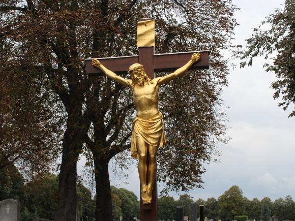 Foto einer goldenen Statue des gekreuzigten Jesus am Friedhof Inzersdorf